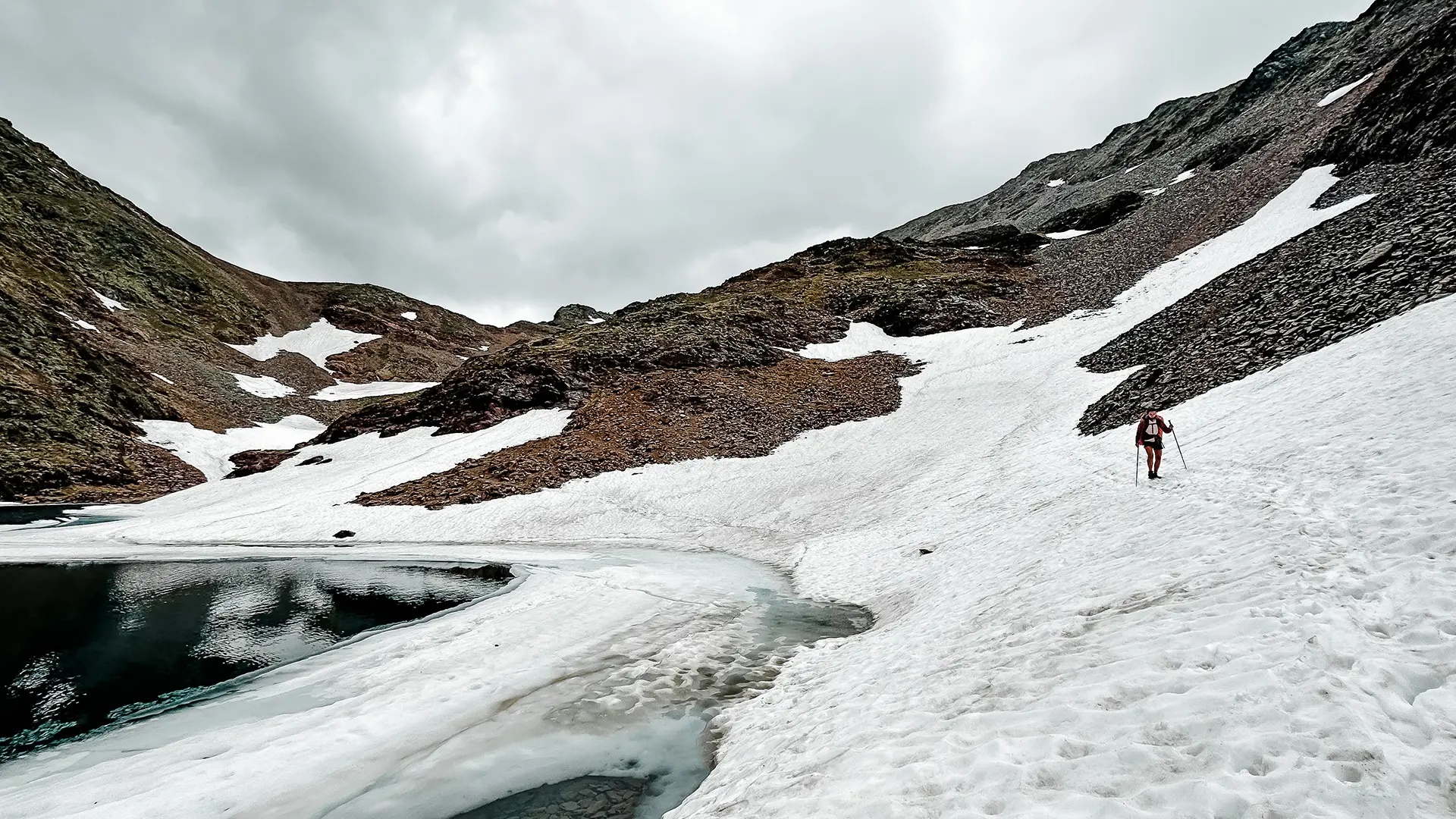 Women hiking in snow covered mountain valley