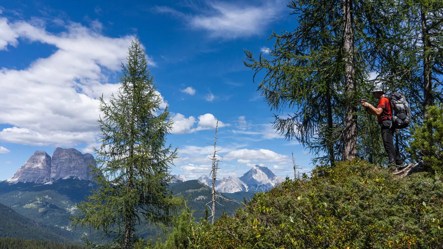 Two hikers looking out on dolomites landscape