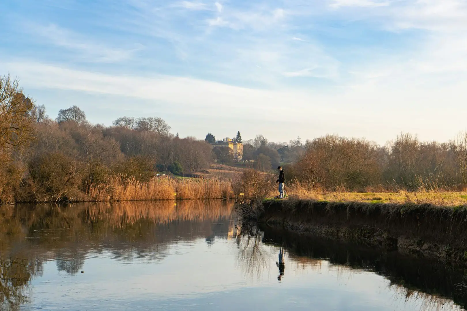 Man fishing beside the Thames near Abingdon in February