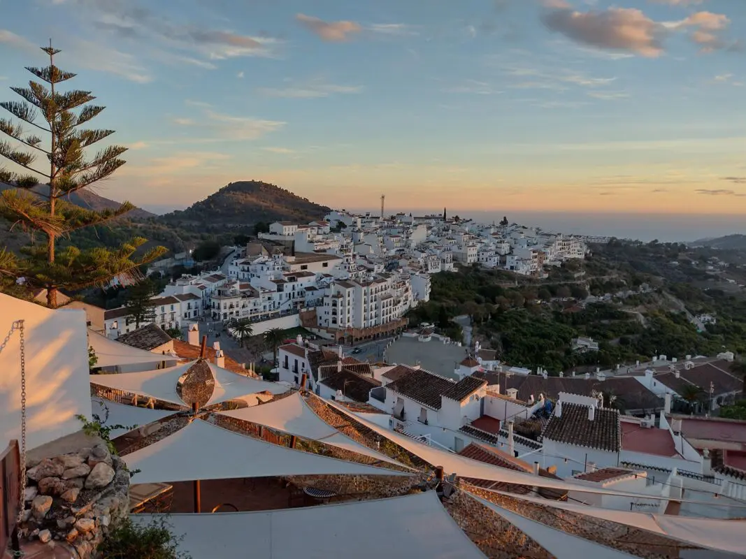 white houses in coastal town near the sea during sunset