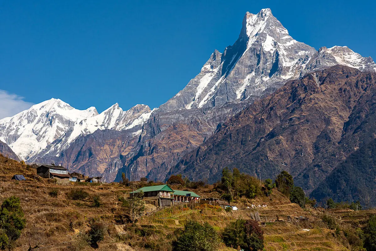 small stone hut with mountains in background