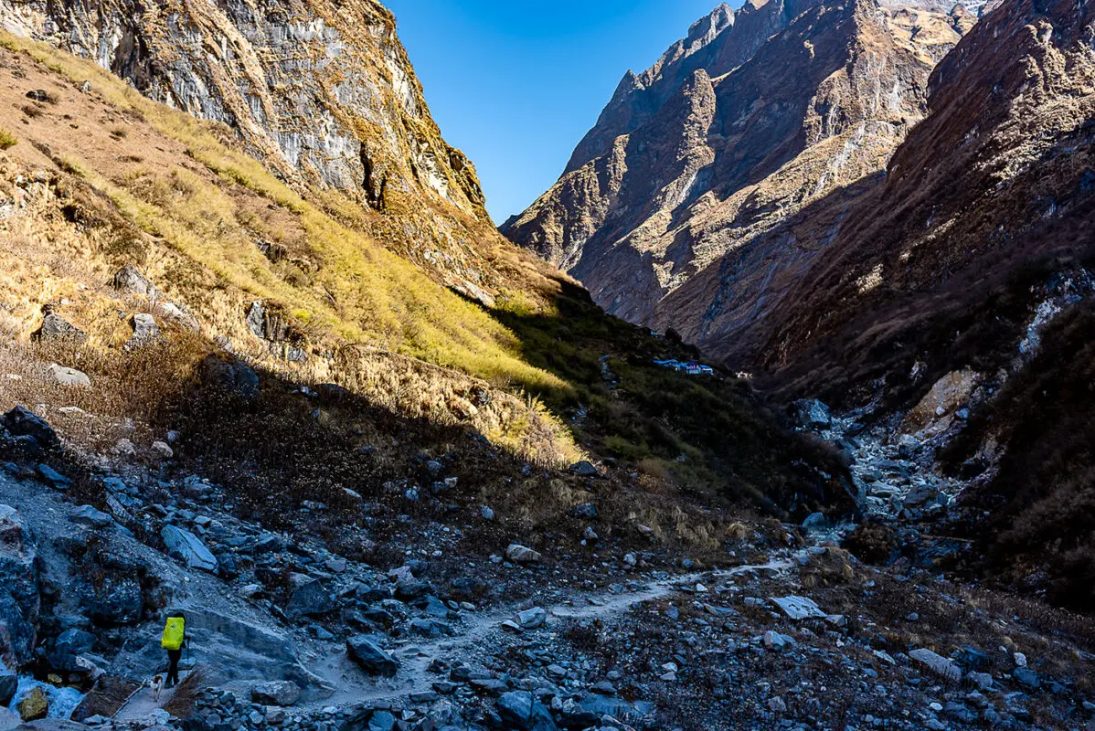 person hiking through mountain valley