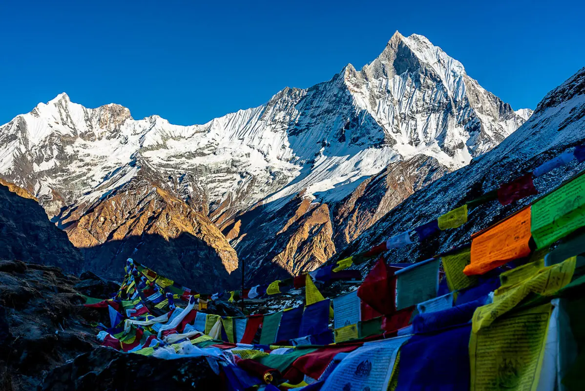 Top of rugged and snow covered mountain peak