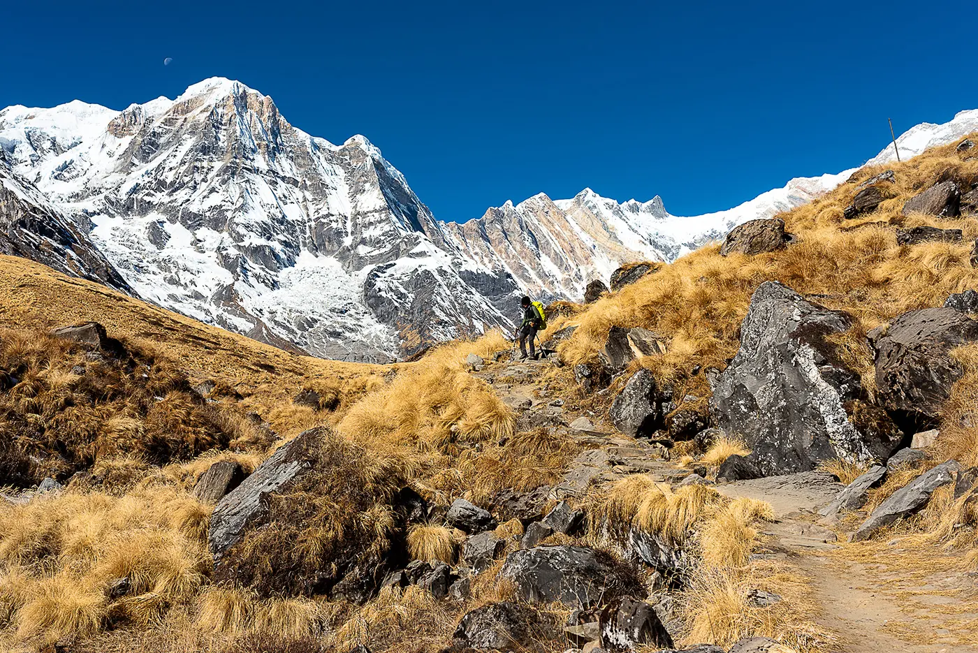 person hiking on small mountain path