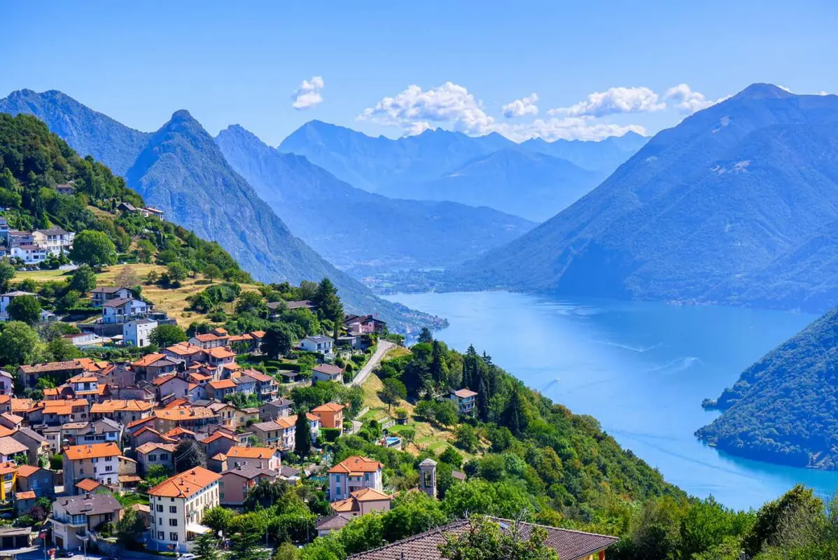 small town on a hill overlooking a big lake