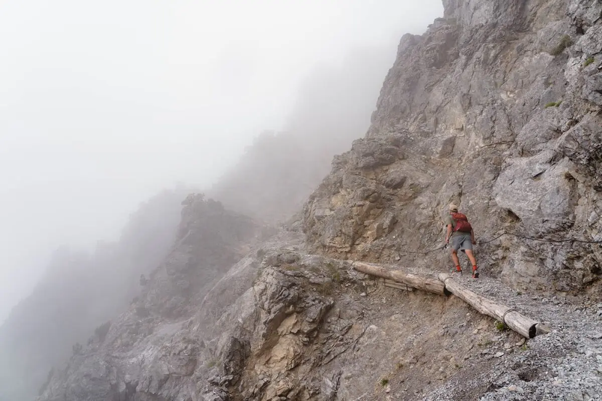 man hiking on small mountain path