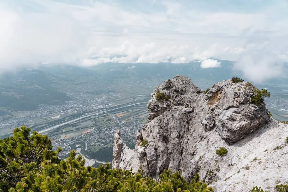 rugged rock formation with city in the valley