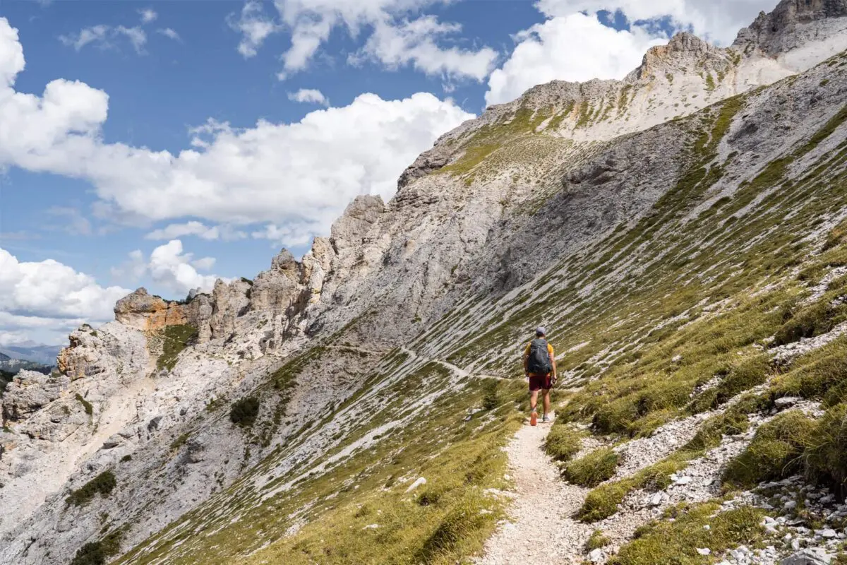 person hiking on small mountain path