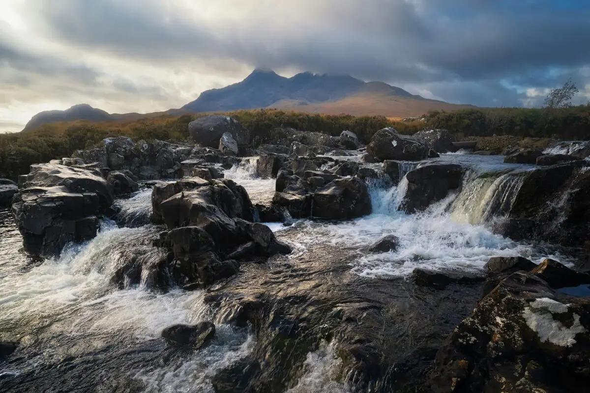 strong river going downstream with mountains in background