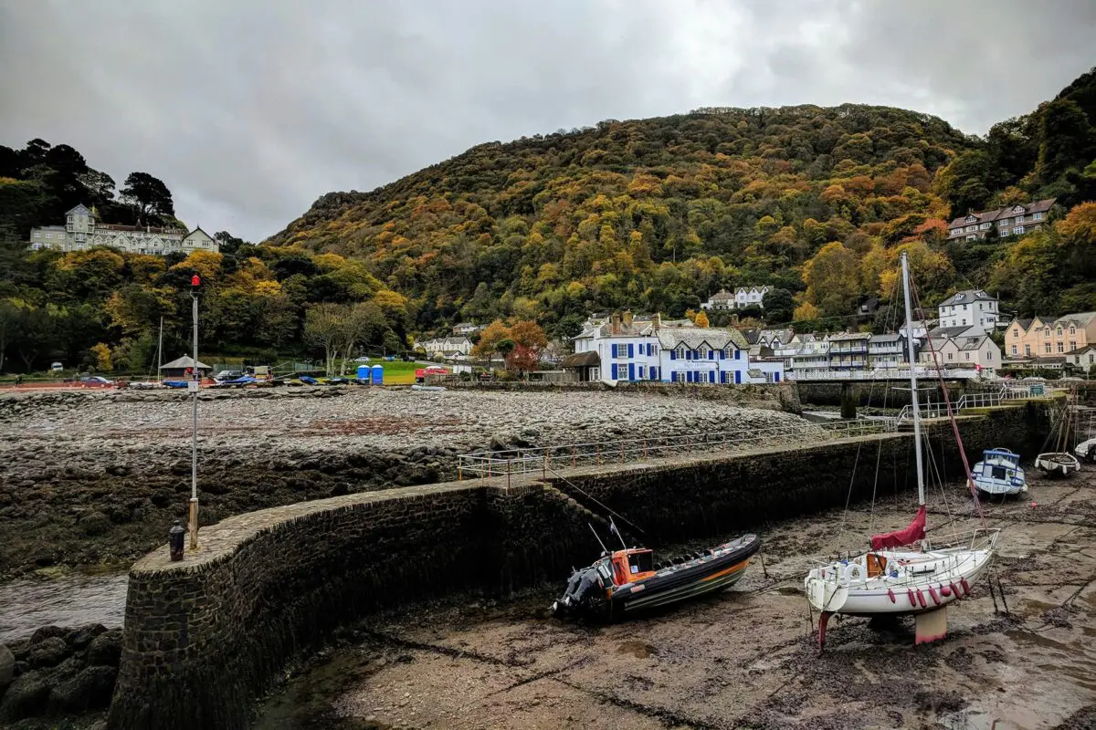 Coastal town near hills with boats in foreground