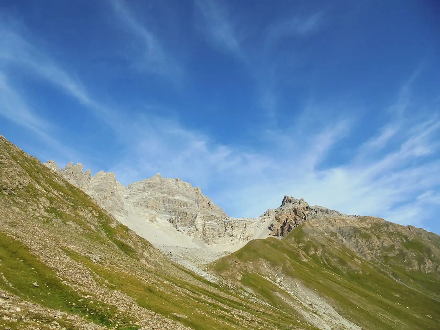 mountain peaks in green landscape during sunny day