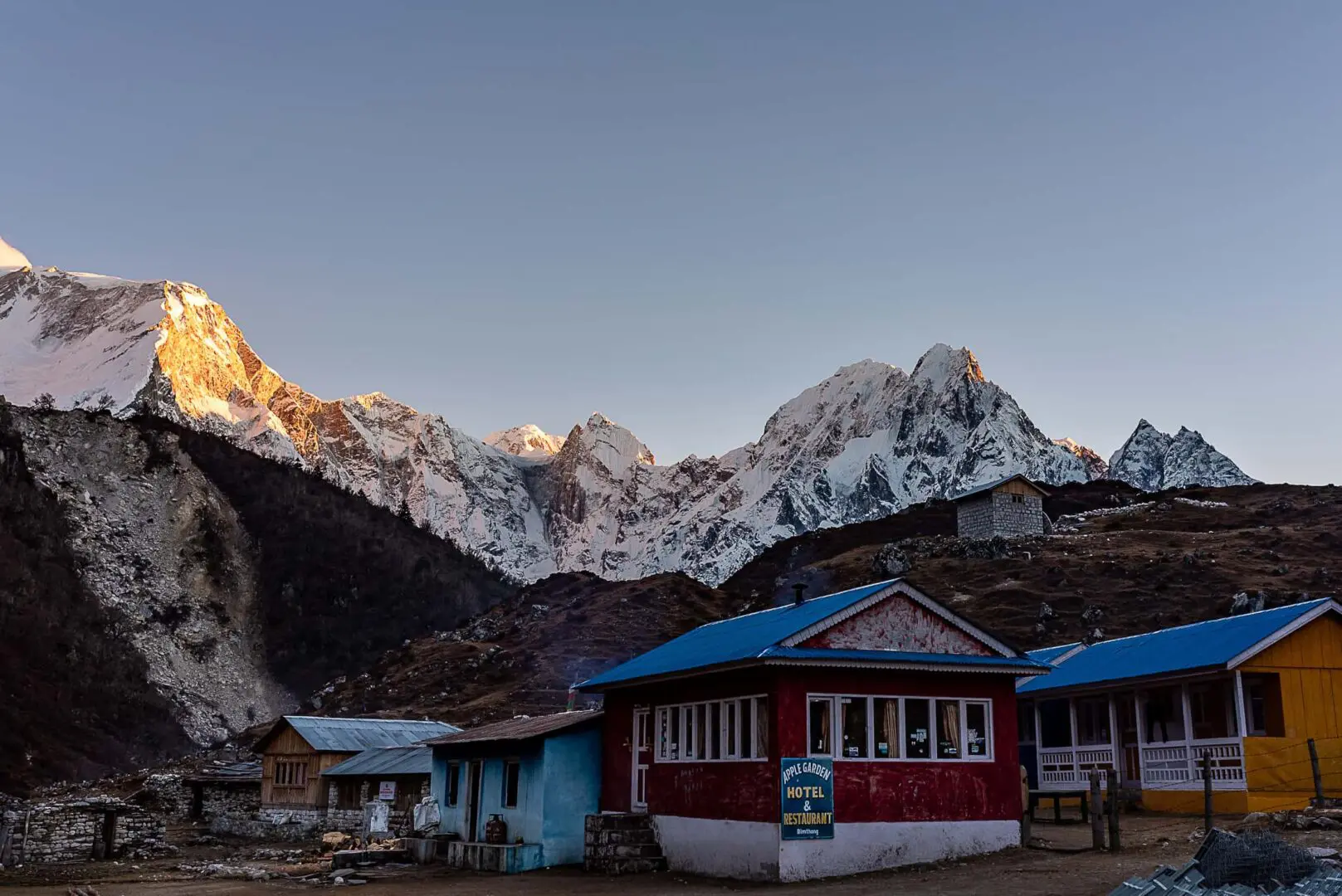 basic hotel with snow covered mountains in background
