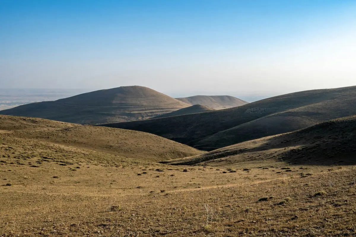 Grey, brown hills with gentle slopes and very few vegetation