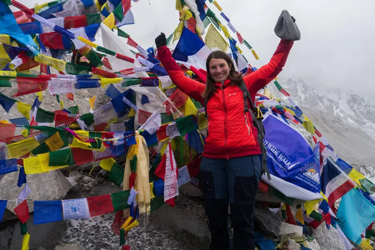 women celebrating in front of prayer flags Nepal