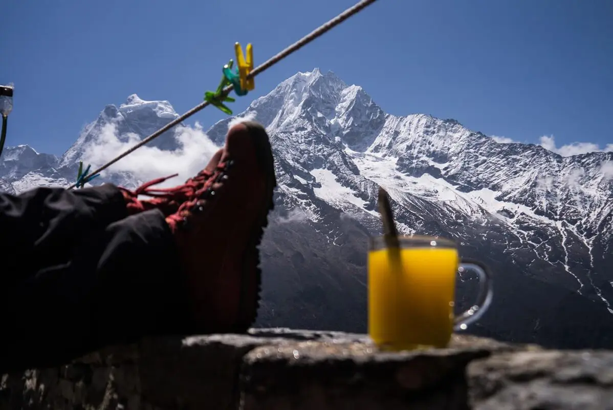 person enjoying view of mountain peak