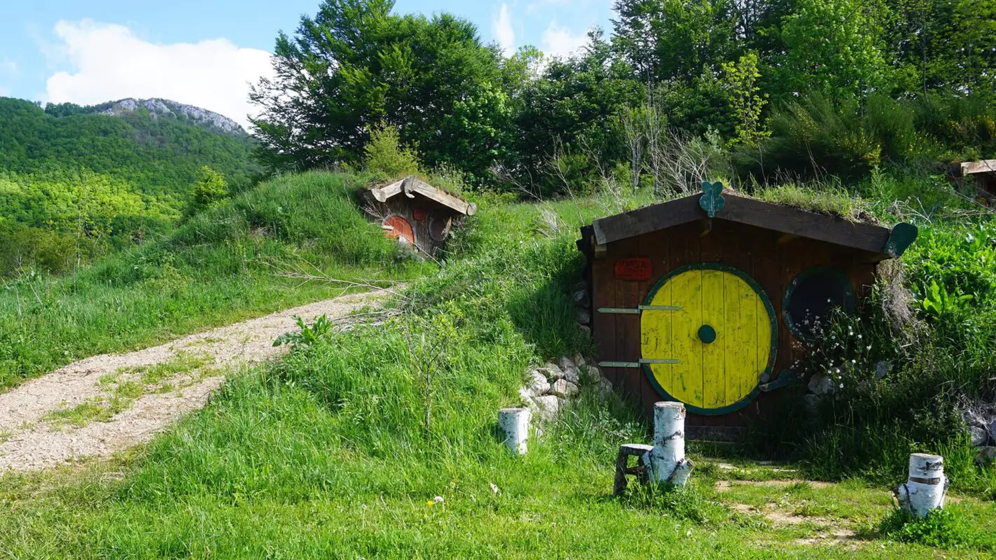 Small shelters embedded in green hills