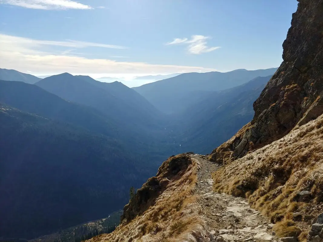 small mountain path with mountains in background