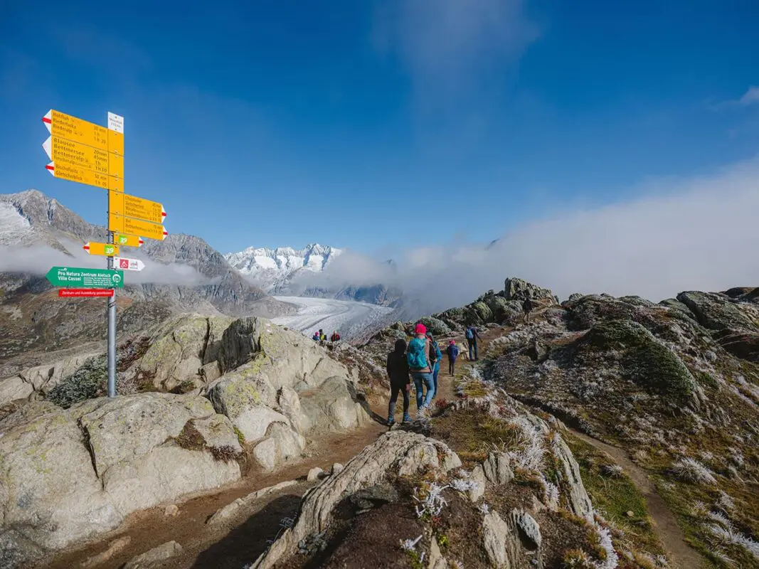 people hiking on unpaved paths in the mountains