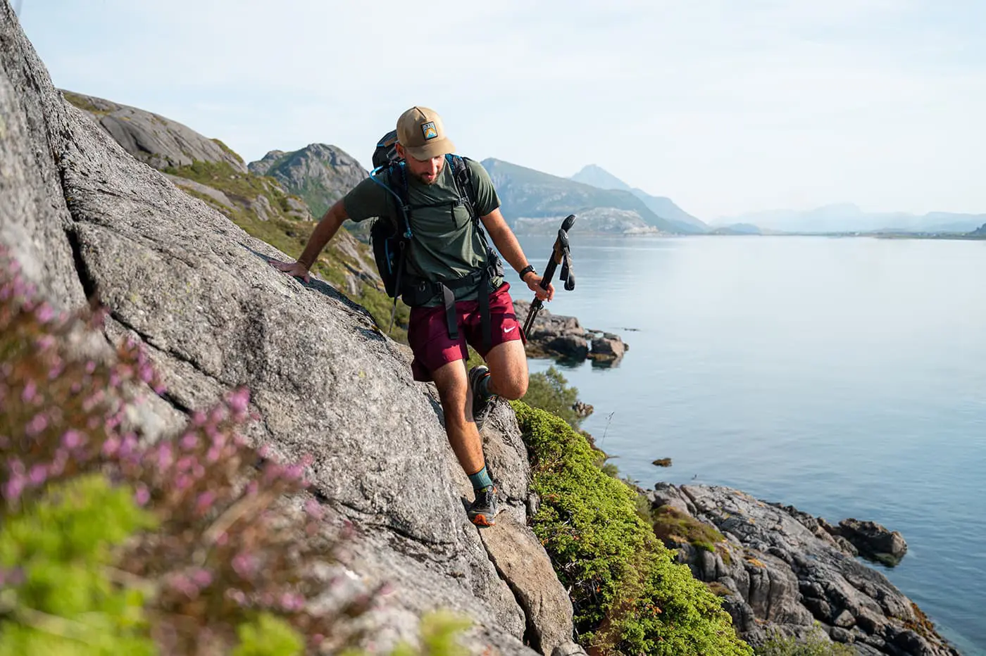 man scrambling on rocks