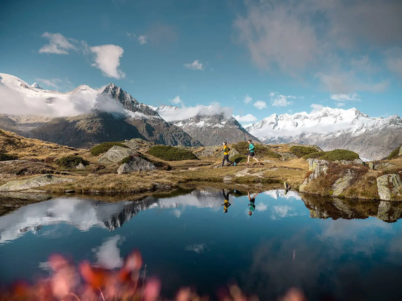 two persons trail running in the mountains