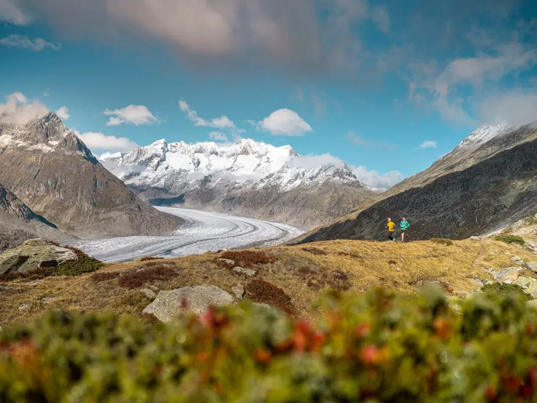 two persons trail running in the mountains
