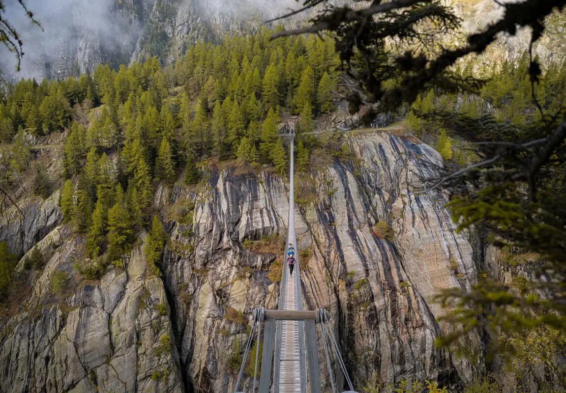 people running over suspension bridge
