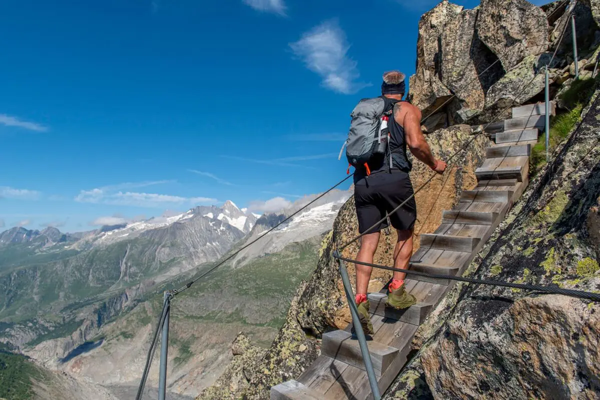 man hiking up wooden steps