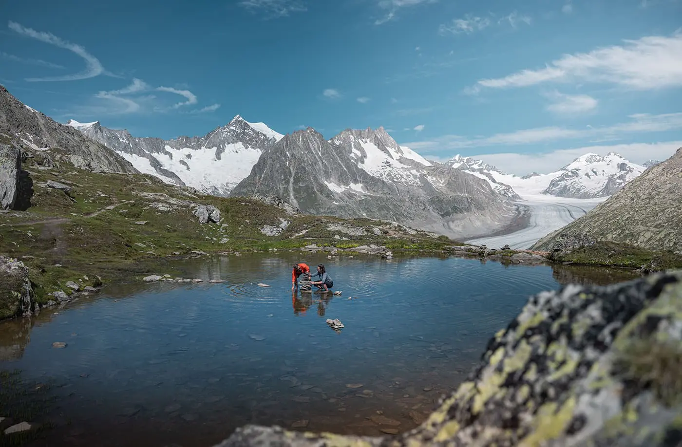 couple in the water near the mountains