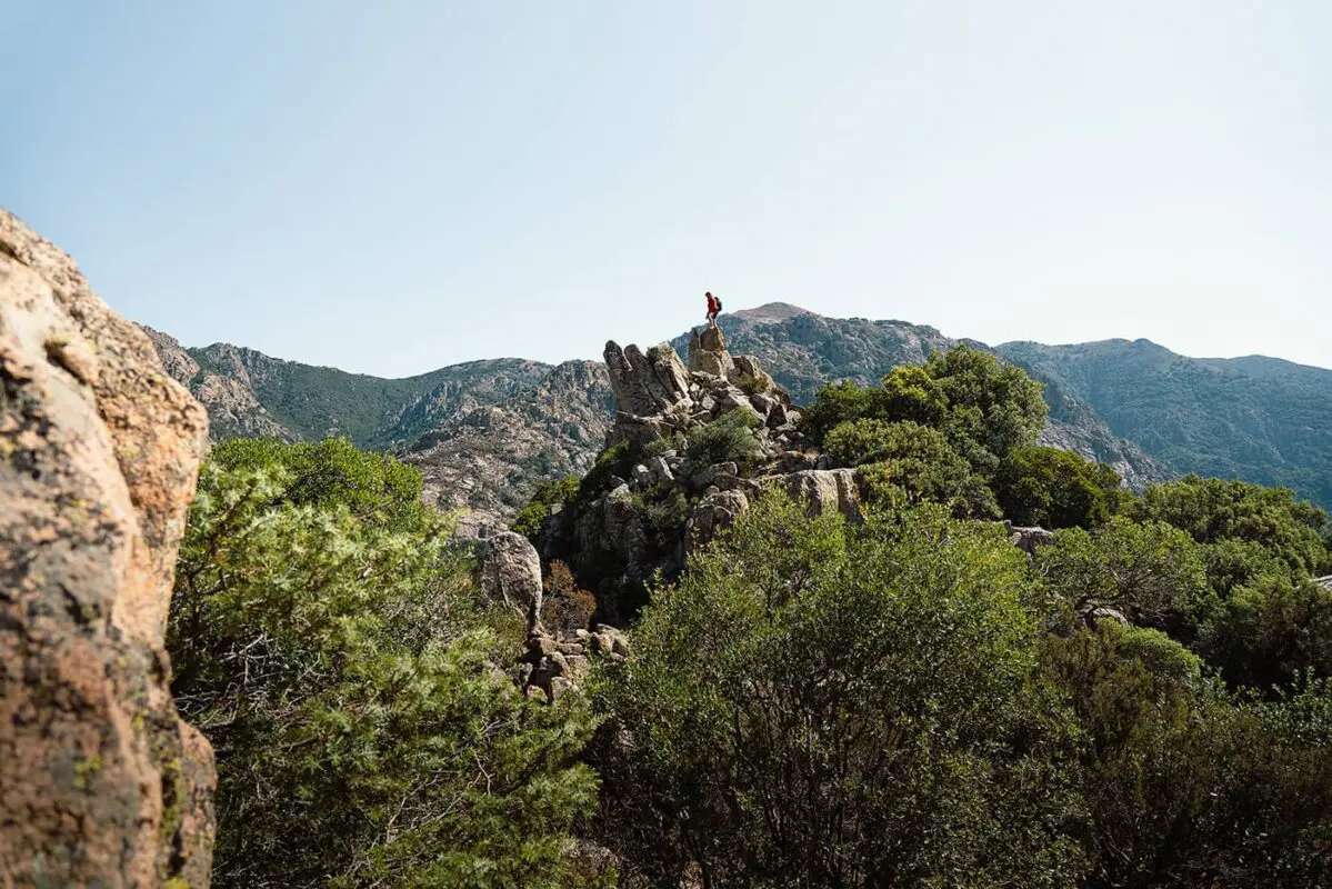 man standing on top of rock formation