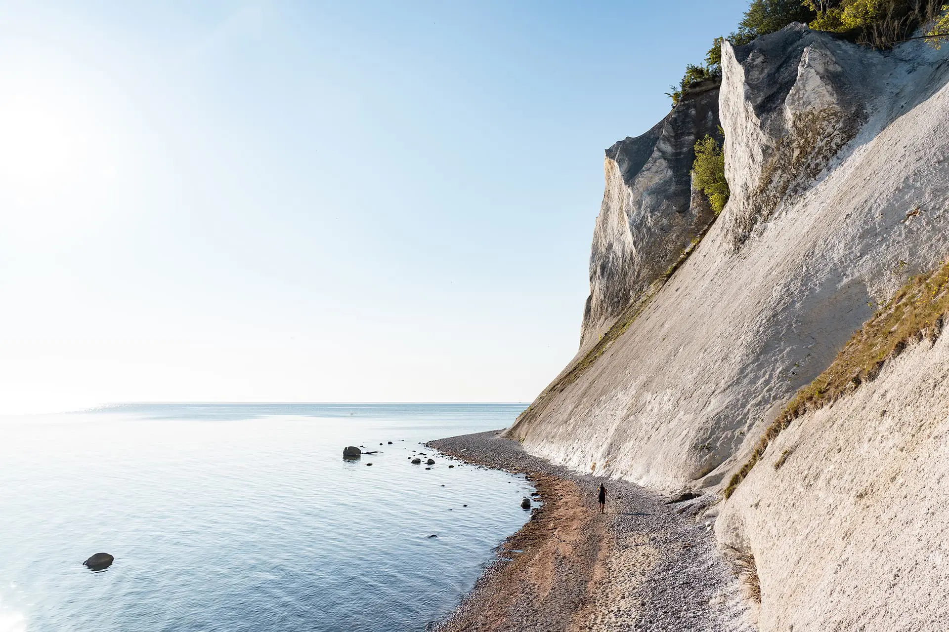 man hiking near white cliffs