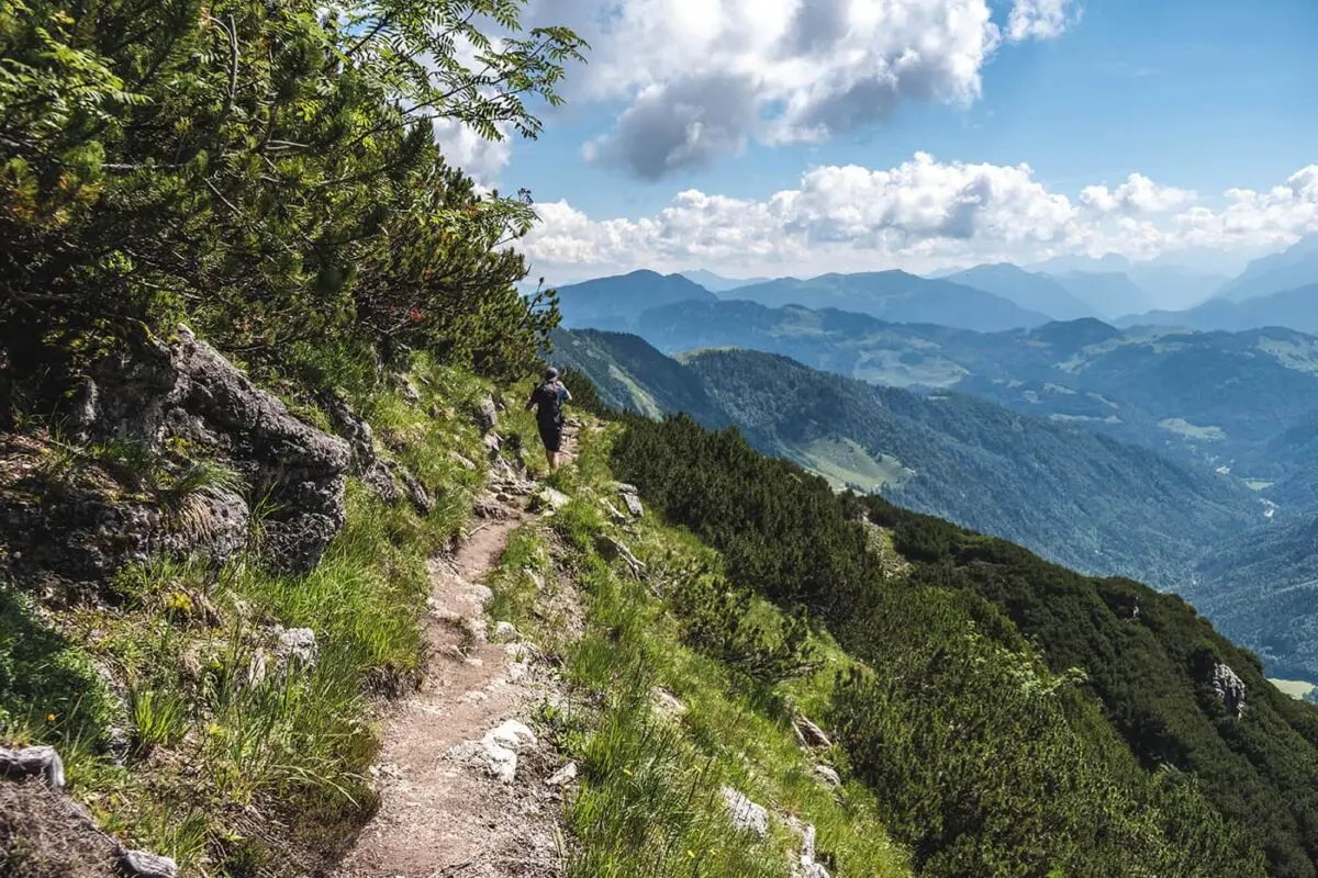 man hiking on small mountain path