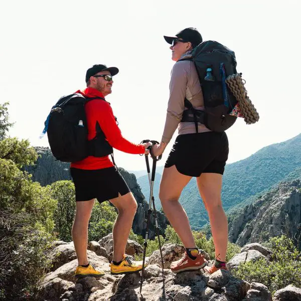 two persons standing on rock