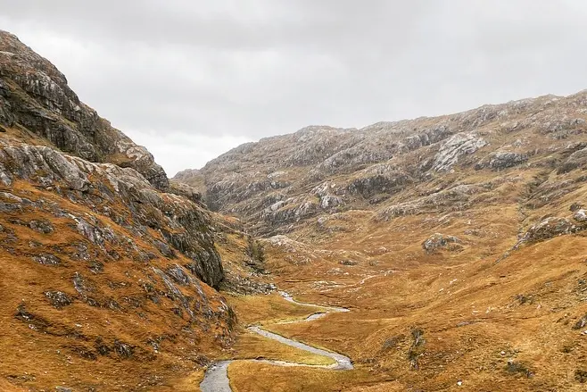 river flowing through rugged hills