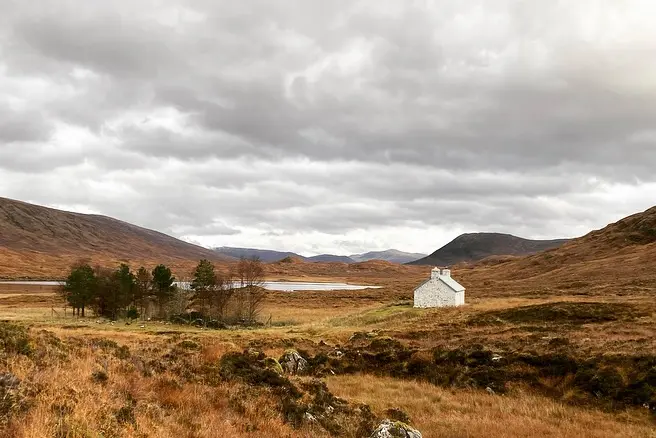 white stone building in moody landscape