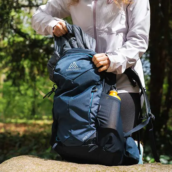 person taking jacket out of back