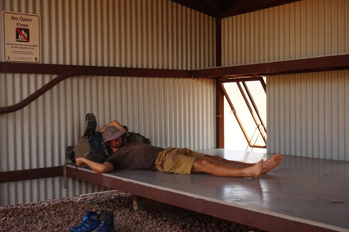 man taking a nap in the shadow