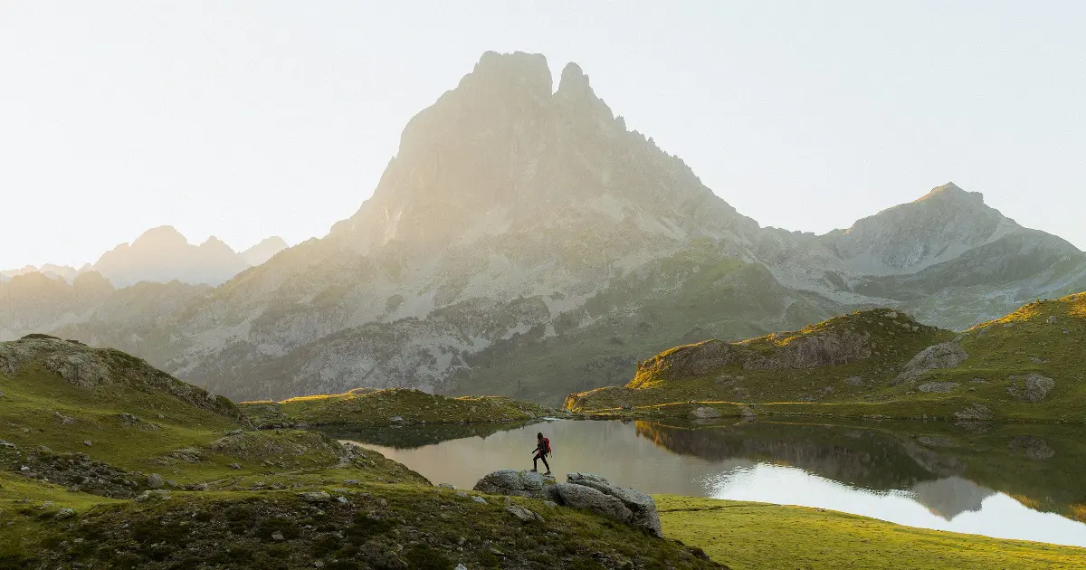 Person walks under peaks at dawn