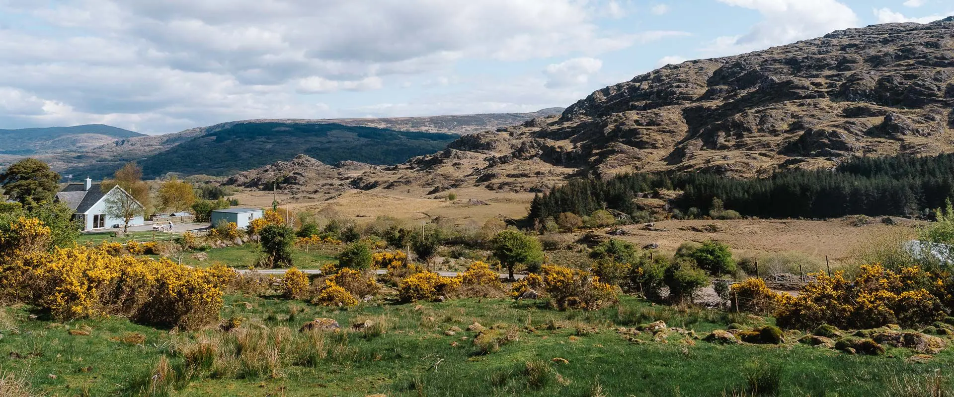 Hills in Ireland with a stone cottage