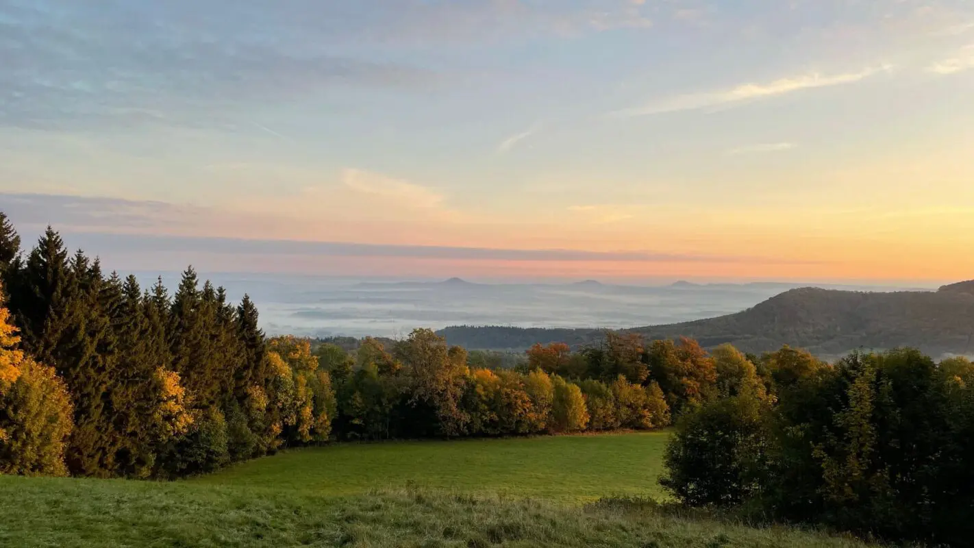 panoramic view of green landscape during sunset