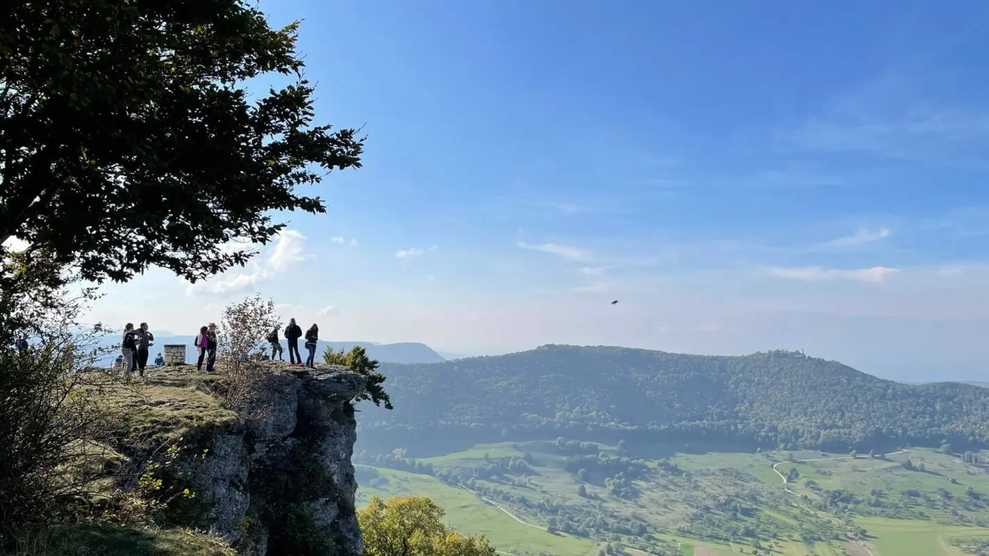 group of people on vantage point looking out over green landscape