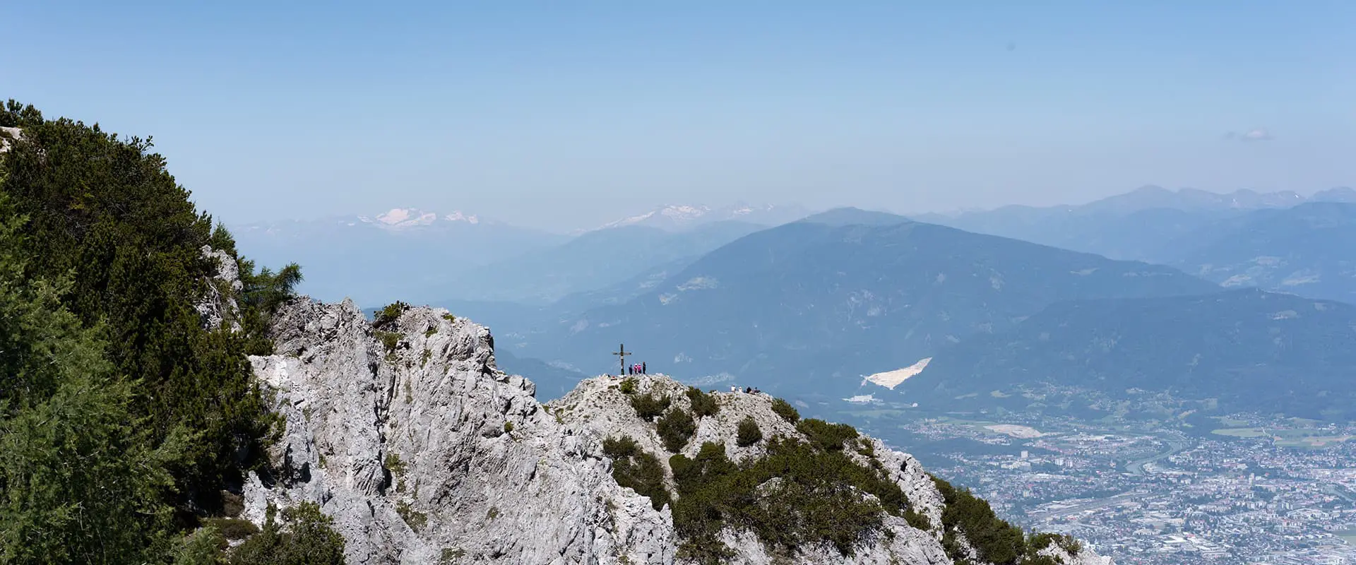 mountain peak on the Alpe Adria Trail looking out over city below