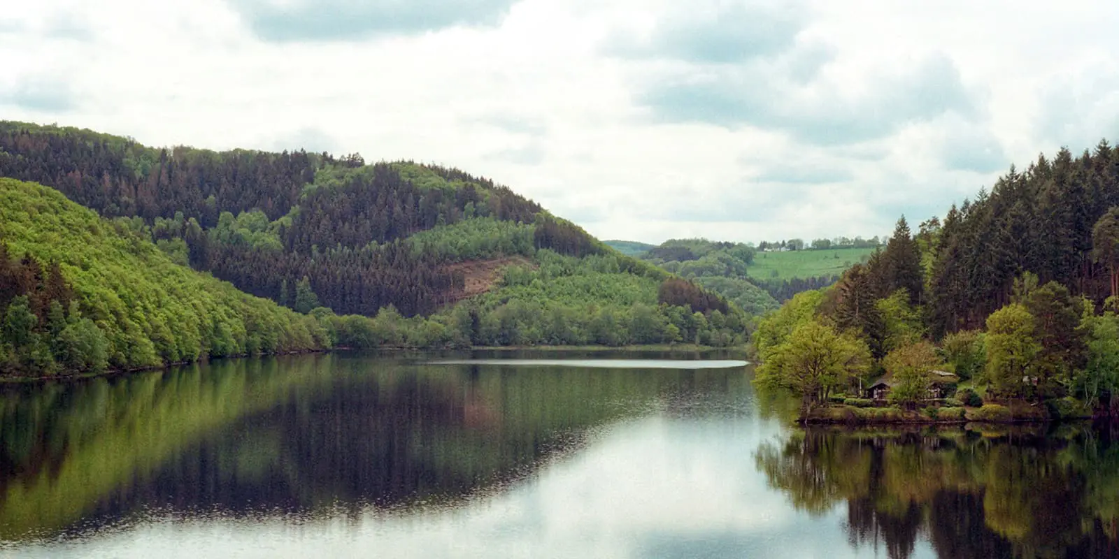 green hills next to body of water in Germany