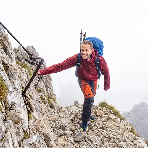 man hiking up mountain