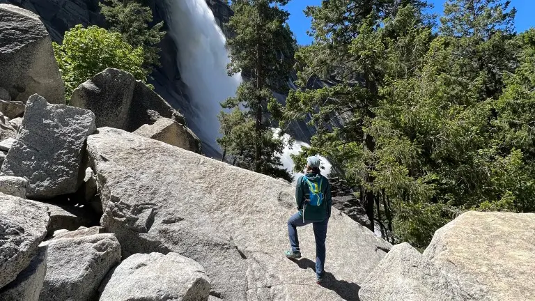 women looking up at waterfall in Yosemite Valley