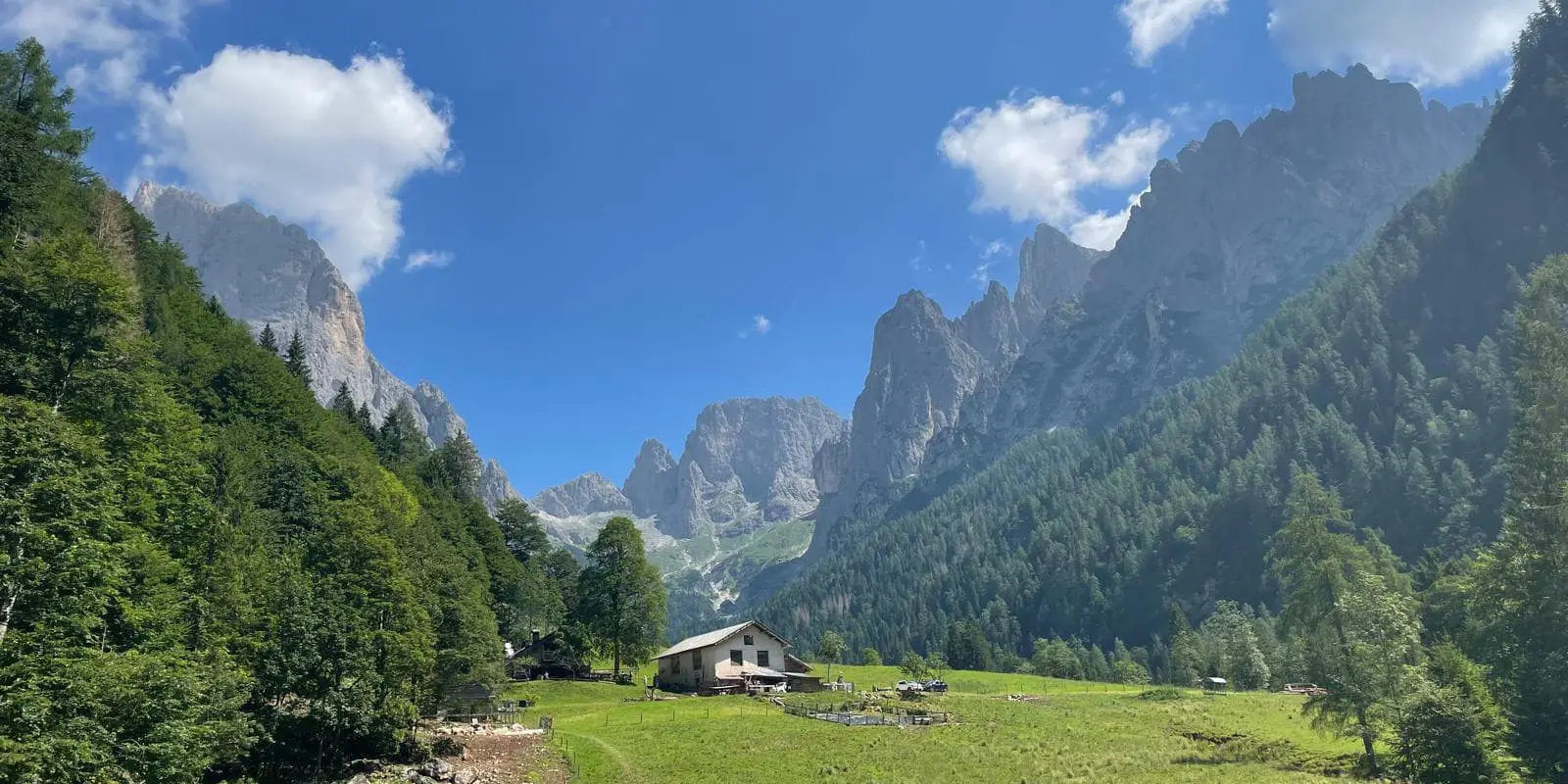 old farm house in mountain valley on sunny day