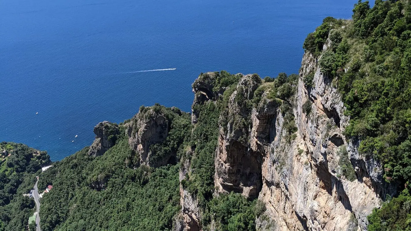 green and rugged peaks near body of water