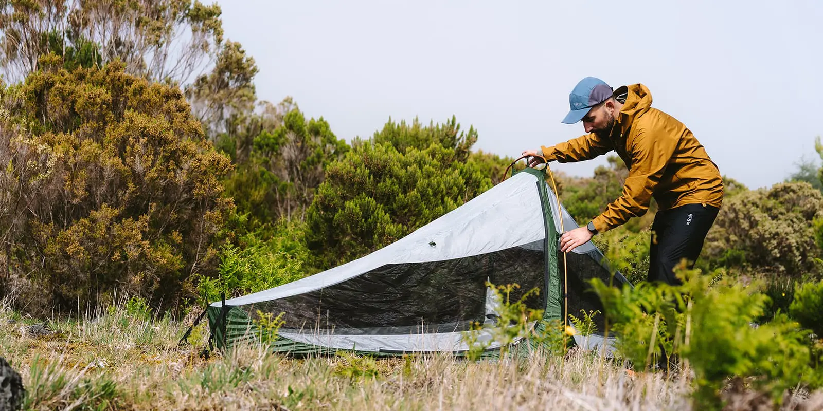 person pitching tent