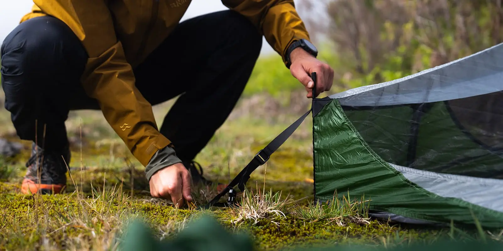 person pitching tent