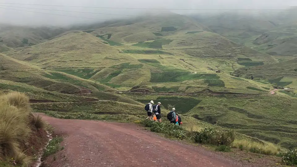 group of hikers in green mountain landscape