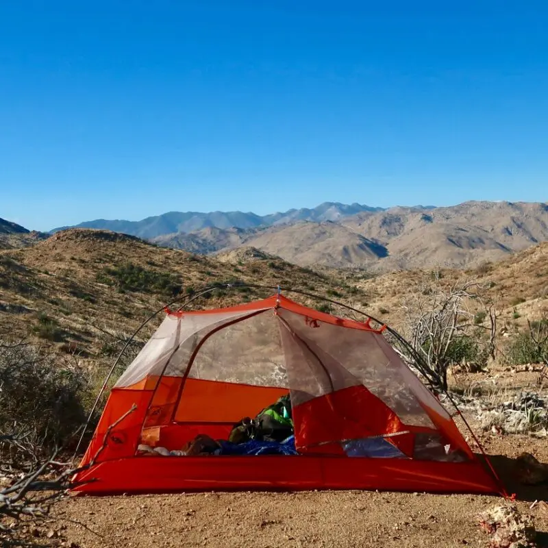 Wild camping in the mountains while hiking a trail